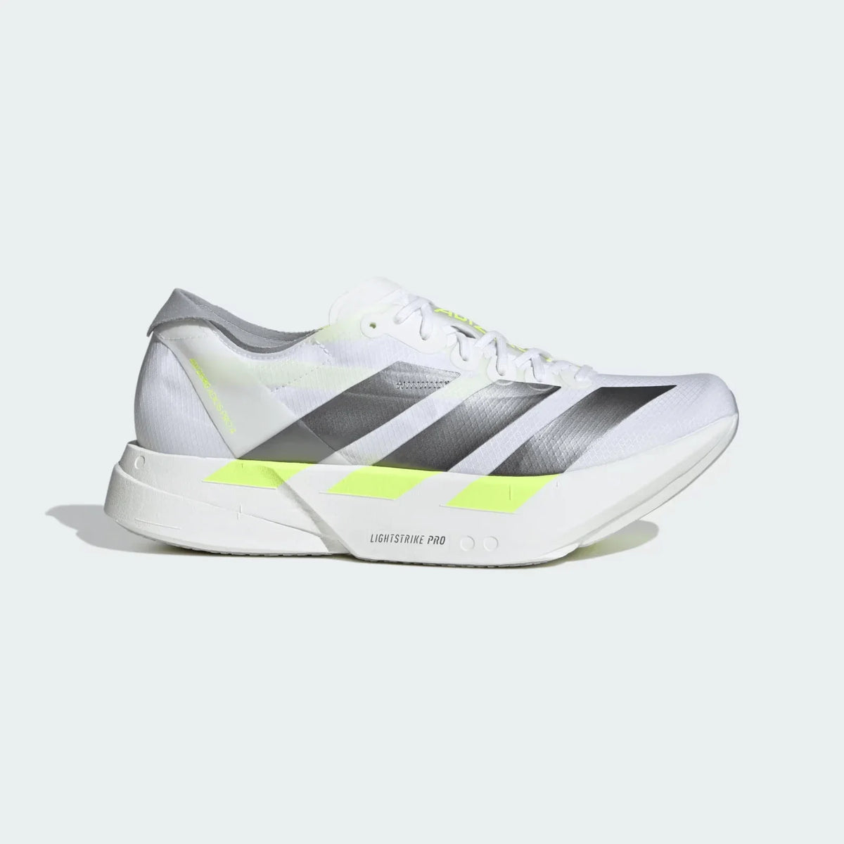 White adidas running shoe with grey stripes and yellow detailing