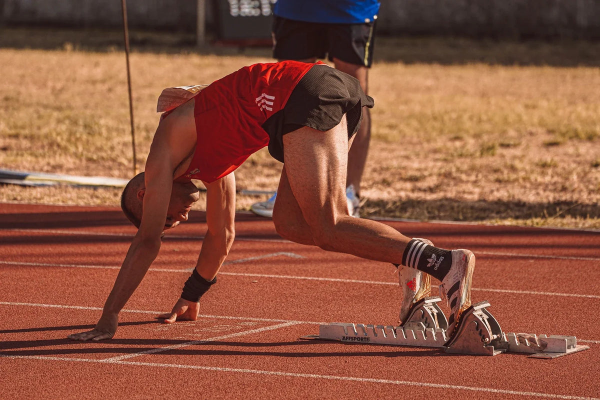 Sprinter preparing to start on an athletics track
