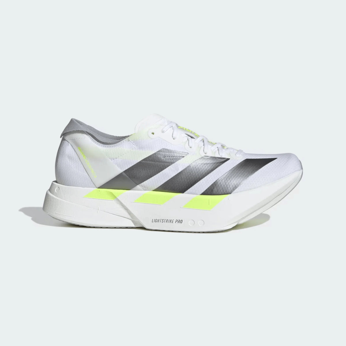 White adidas running shoe with grey stripes and yellow detailing
