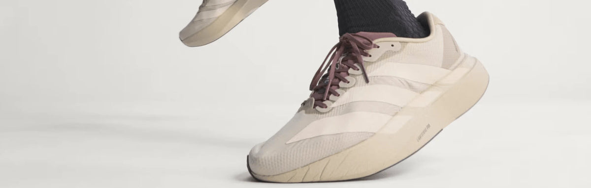 Close-up of a light-coloured running shoe in motion