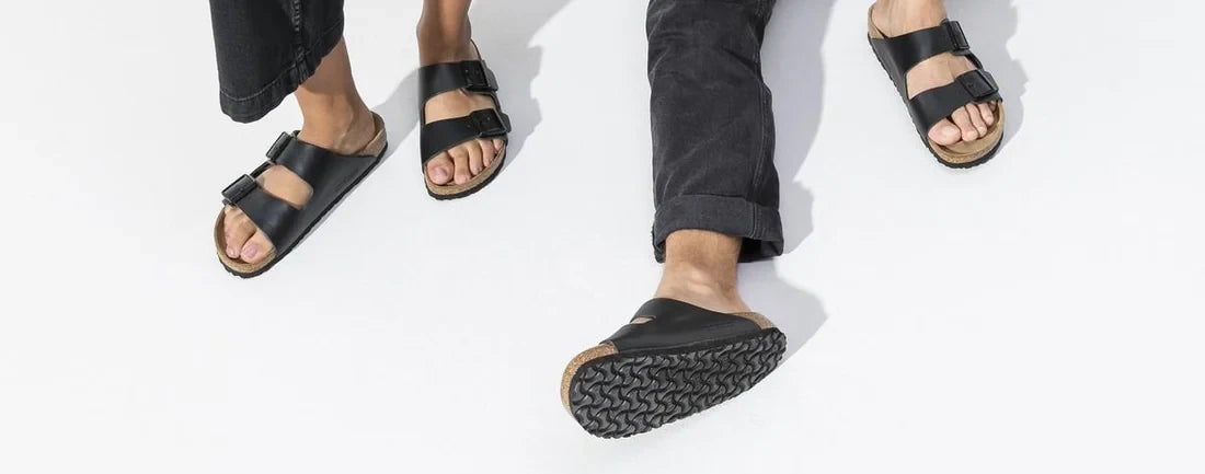 Black two-strap Birkenstock sandals being worn