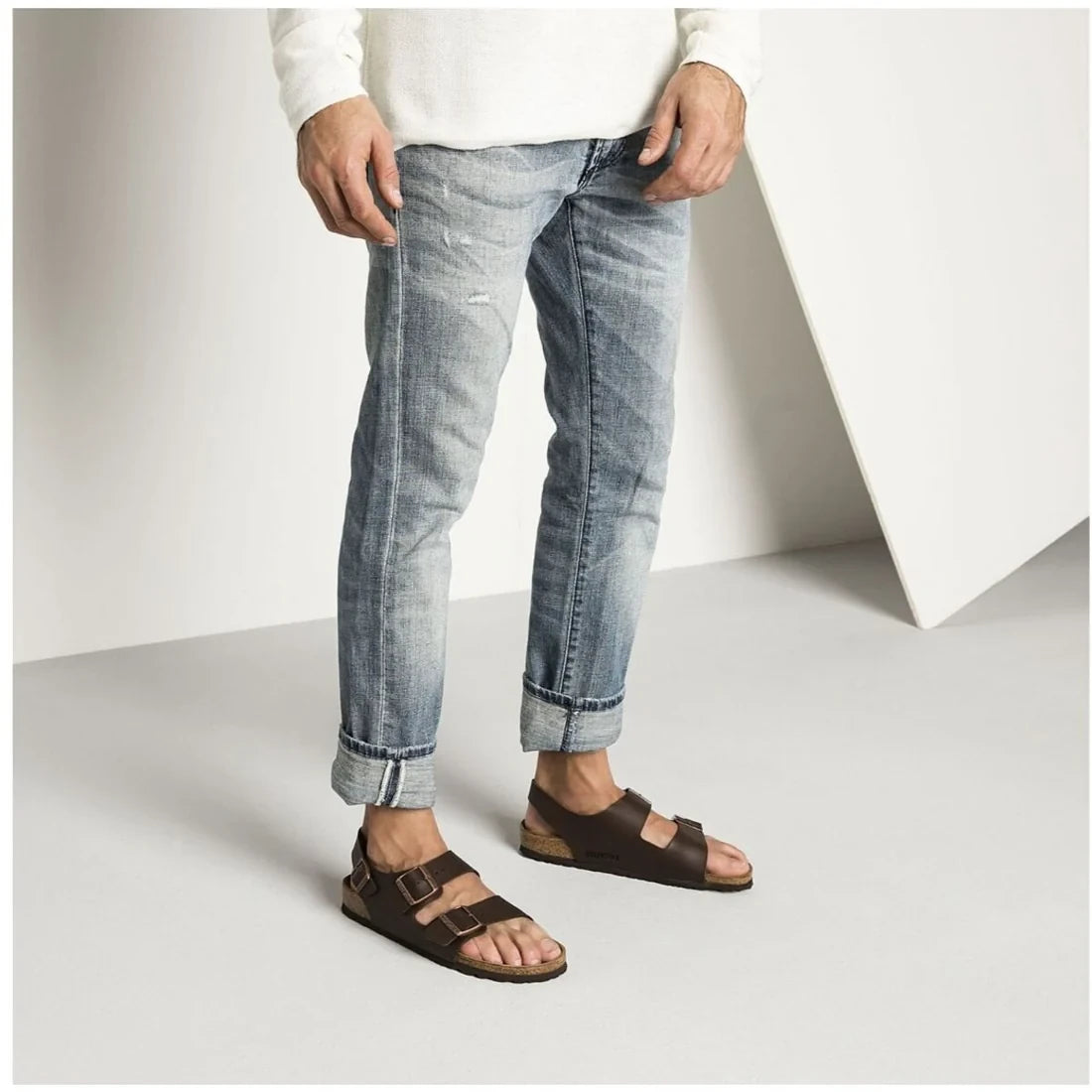 Brown Birkenstock sandals with a back strap worn with jeans