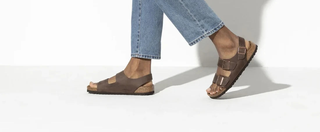 Side view of brown Birkenstock sandals with a back strap
