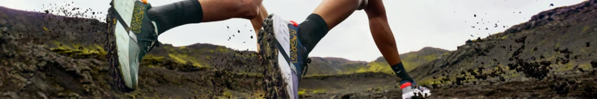 Trail runners crossing rocky ground