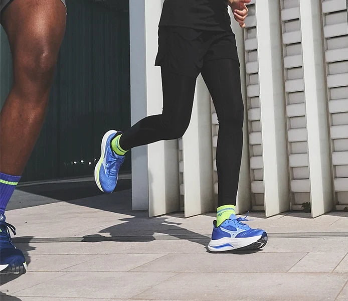 Runners wearing blue and yellow running shoes
