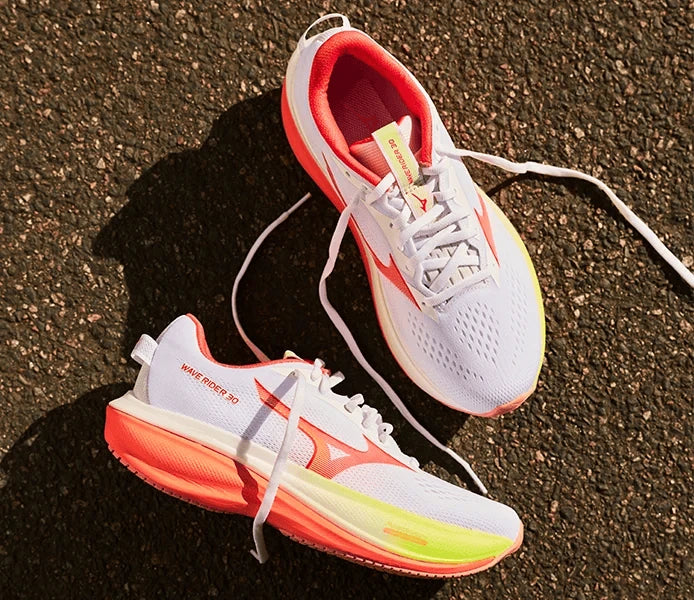White running shoes with bright coral soles