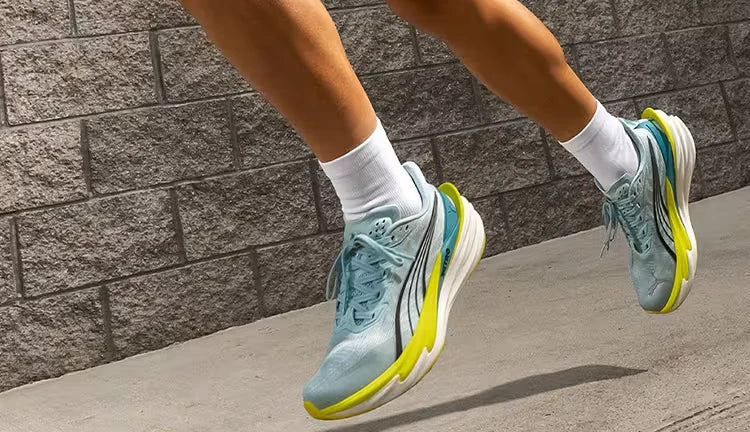 Light blue running shoes with yellow soles in motion