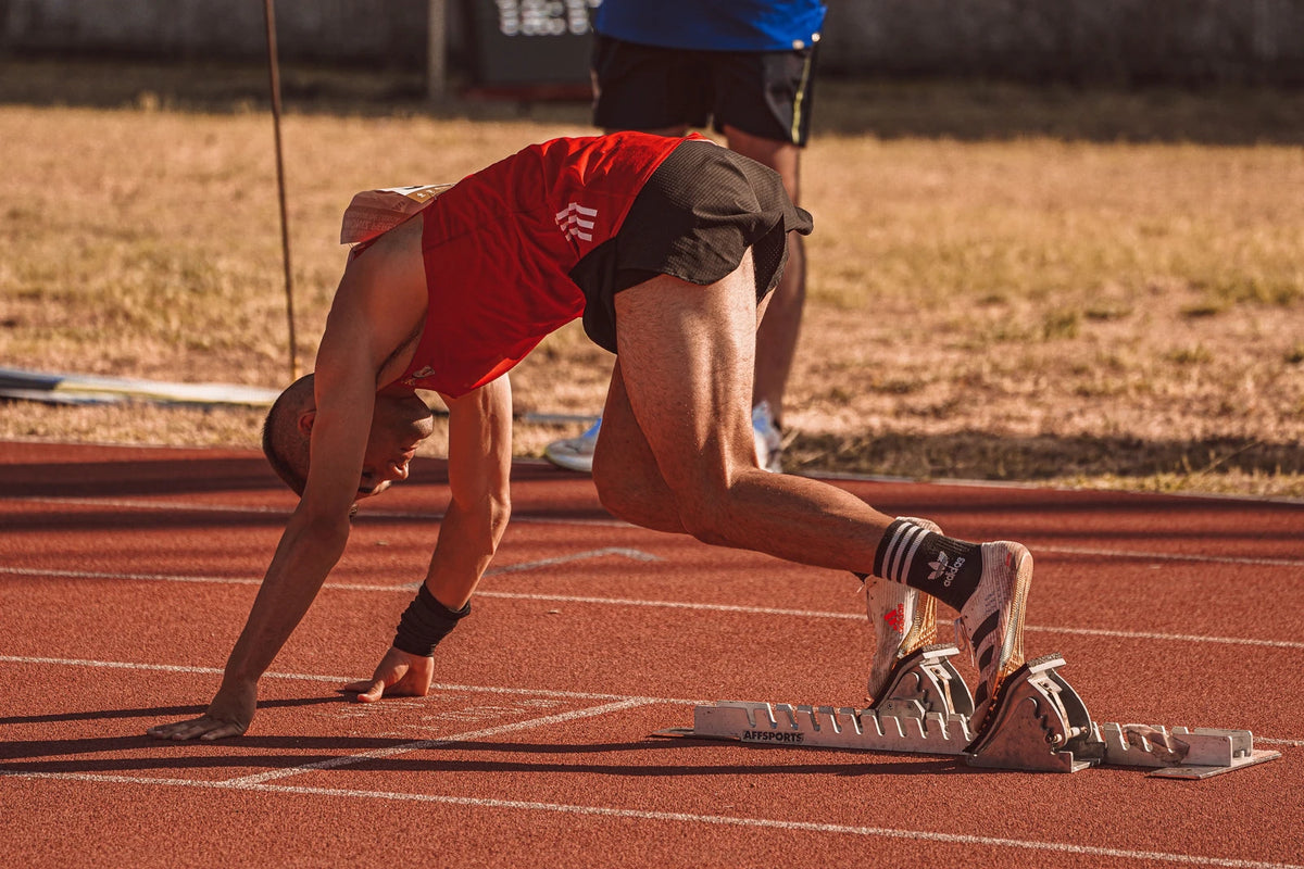 Sprinter preparing to start on an athletics track